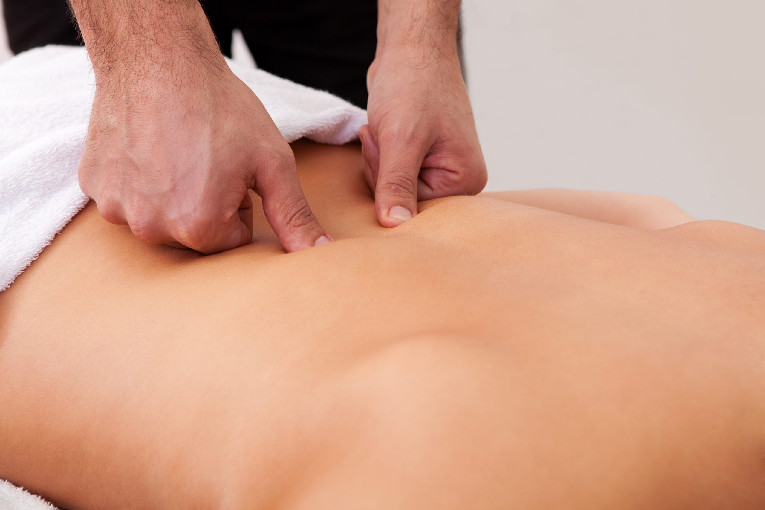 Young beautiful woman getting back massage. Spa studio shot